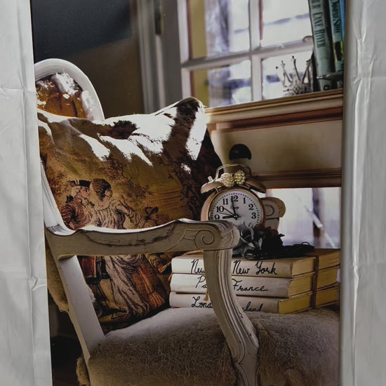 Antique chair, books, and clock in cottage home photography canvas print video preview